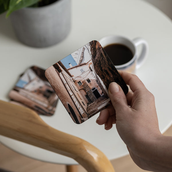 Holding a personalised photo coaster with holiday photo