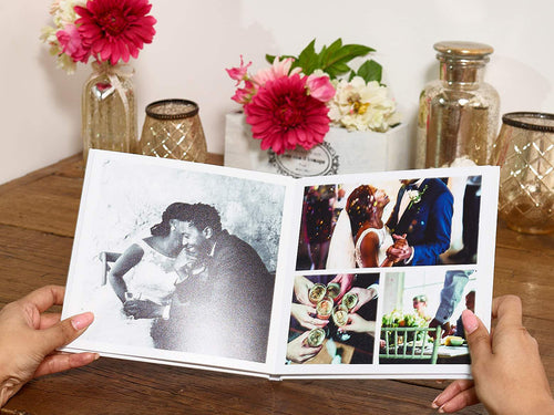 Holding a wedding photobook with images from wedding day